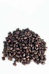 Coffee Beans on white background. Coffee grounds. Freshly roasted coffee beans. Image of a drink made from granules, derived from coffee plant. Copy space for text.