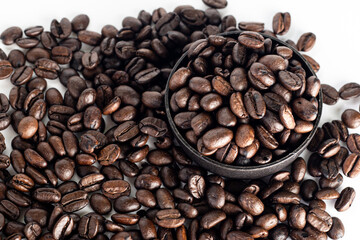 Coffee Beans on white background. Coffee grounds. Freshly roasted coffee beans. Image of a drink made from granules, derived from coffee plant. Copy space for text.
