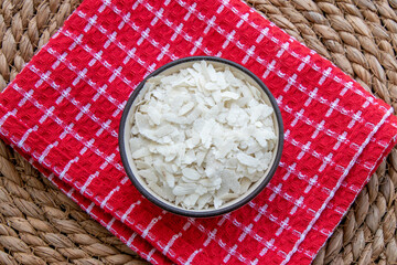 Flattened rice on wooden texture