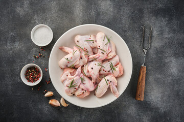 Uncooked chicken wings with spices. Raw meat. Raw Chicken wings.