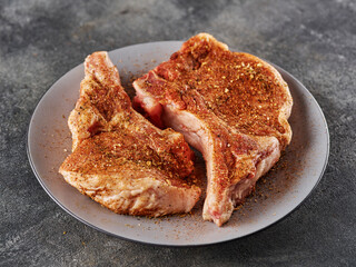 Fresh  Raw porks loin with bone seasoned with dry marinade done for bbq.