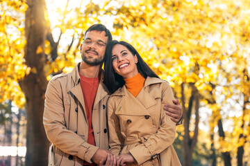 Fototapeta premium Couple in love walking on autumn park, enjoying a beautiful autumn day.