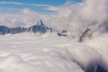 Fototapeta na wymiar Beautiful alpine scenery in the Swiss Alps in winter, with dramatic cloudscape
