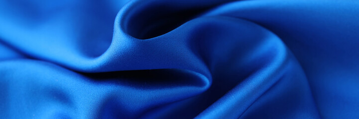 Blue satin fabric closeup. Natural fabric or polyester satin concept