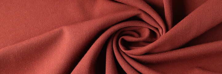 Red silk luxury drapery fabric texture background closeup