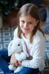 a girl sitting in a room with Christmas decoration