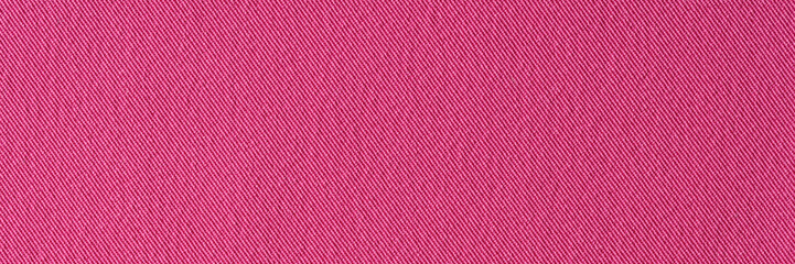 Red pink denim textile background closeup. Textile fabric with stitch structure