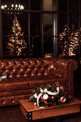 Brown leather sofa and wooden table and Christmas decorations in the living room