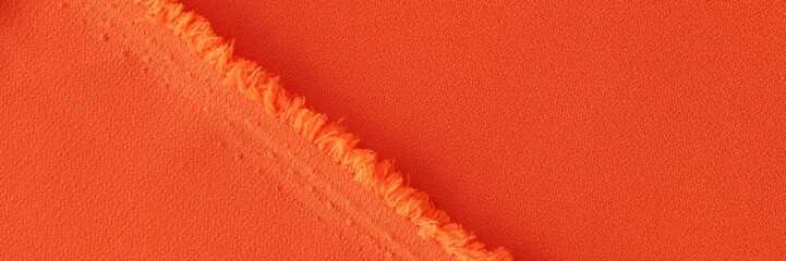 Orange fabric and texture of threads of bright orange fabric with folds
