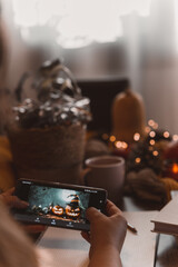 autumn photo on table with candles watching smartphone