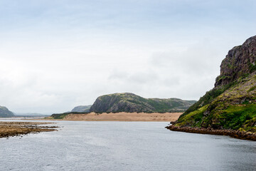 Summer tundra. Rocky coastline of Barents Sea near Teriberka. Scenery of Russian North. Kola Peninsula, Murmansk Oblast, Russia