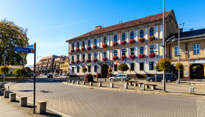 Colorful Town Hall Ratusz and local Council House at Rynek Market Square in historic old town quarter of Andrychow in Poland - obrazy, fototapety, plakaty
