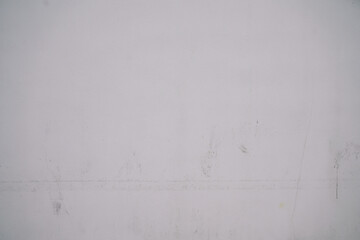 background plastered cement dirty and marked white wall worn by time