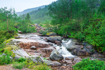 rapids of mountain rivers with fast water and large rocky boulders