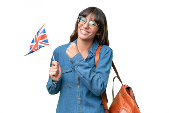 Young caucasian woman holding an United Kingdom flag over isolated background celebrating a victory