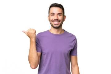 Young handsome caucasian man over isolated background pointing to the side to present a product