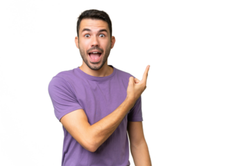 Young handsome caucasian man over isolated background surprised and pointing side