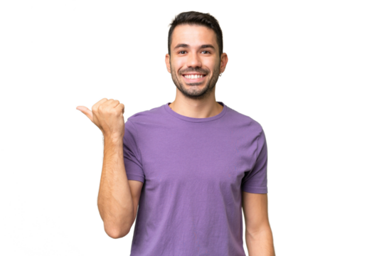 Young handsome caucasian man over isolated background pointing to the side to present a product