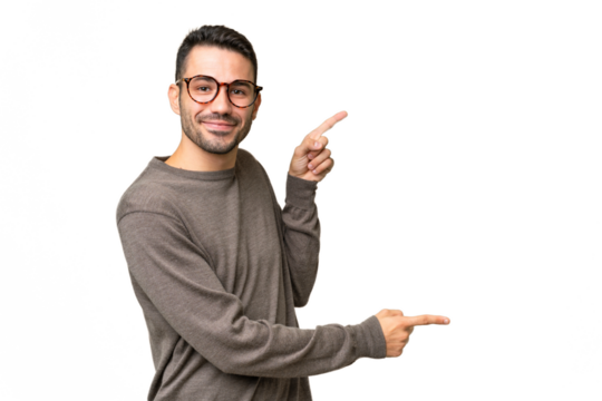 Young handsome caucasian man over isolated background pointing finger to the side and presenting a product