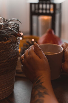 autumn photo on table with candles drinking coffee