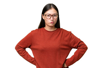 Young Asian woman over isolated background having doubts while looking up