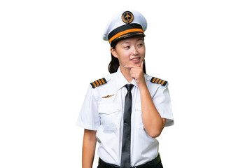 Airplane pilot Asian woman over isolated background looking to the side