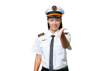 Airplane pilot Asian woman over isolated background shaking hands for closing a good deal