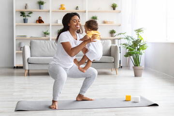 Workout With Baby. Cheerful Black Woman Exercising At Home With Infant Son