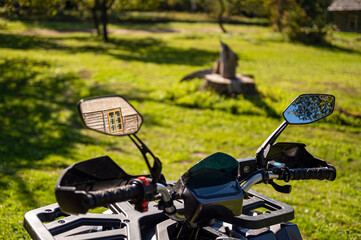 quad bike in the yard of a traditional Latvian rural homestead