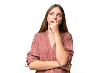 Young beautiful blonde woman over isolated background having doubts and with confuse face expression
