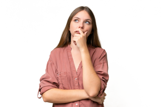 Young beautiful blonde woman over isolated background having doubts and with confuse face expression