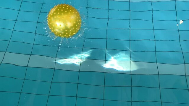 Yellow Ball Falling in the Water in Slow Motion in Switzerland.