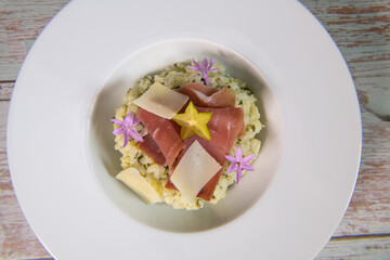 Recipe for risotto with dry ham, parmesan and rocket. High quality photo