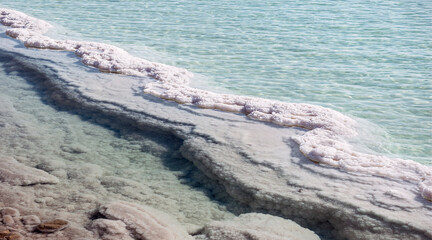 S-shaped salt formation snakes through an evaporation pond in the industrial area of the Dead Sea...