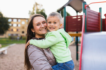 Smiling mother and son in park