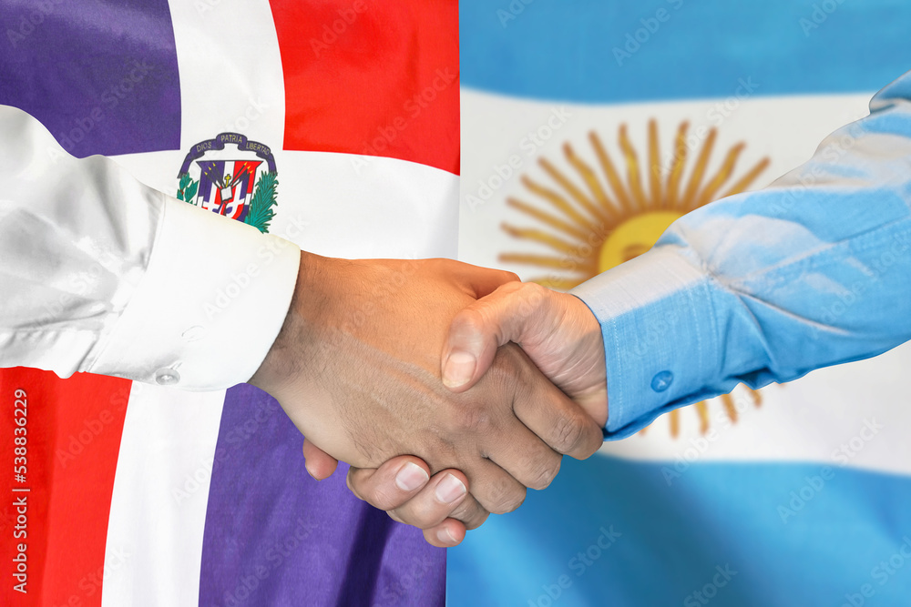 Wall mural business handshake on background of two flags. men handshake on background of dominican republic and