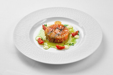 Salmon sous vide with spices in a white plate on a white background. Close-up, selective focus.