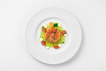 Salmon sous vide with spices in a white plate on a white background. Close-up, selective focus.