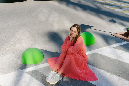 Contemplative woman sitting on road