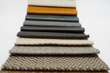 Colorful and bright fabric pattern palette texture samples as abstract textile background. Handmade, clothes and furniture decoration concept. Closeup studio shot with soft selective focus. Toned.