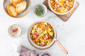 Smoked sausage minestrone tubetti pasta or orzo. Traditional Italian soup with pasta and seasonal vegetables.