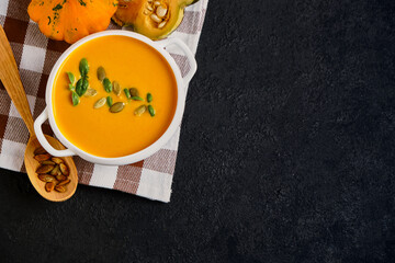 Pumpkin cream soup with pumpkin seeds served