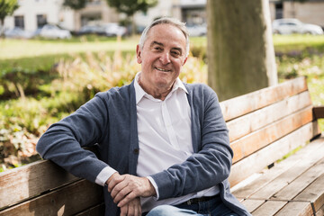 Smiling senior man sitting on bench