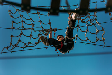 Young rock climber in the adventure park