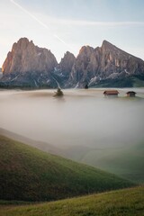 Vertical view of a beautiful sunrise on snowy hills and rocks with mist in South Tyrol © Lukas Leitner/Wirestock Creators