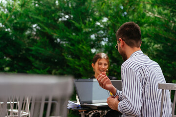 Fototapeta premium Two business people sitting in a coffee bar