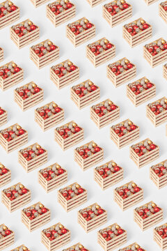 Colorful christmas baubles in wooden boxes repeating on white background