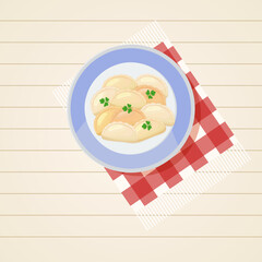 Dumplings in a golubuy tarekle on a white wooden table top view