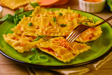 Homemade Pumpkin Ravioli with ricotta cheese served basil