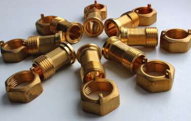 Male Brass Water Meter Fittings And Union Nuts Laid Out In The Form Of Flower On White Surface 
